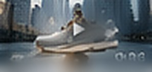 Sneaker above water with a city behind it