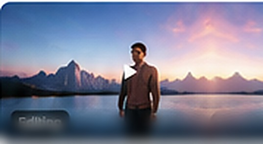 Man standing before mountains at sunset